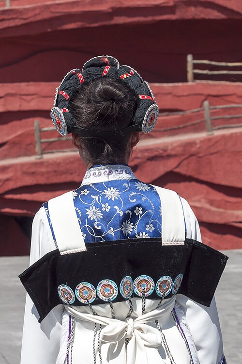 Back of a Naxi woman's dress showing the seven embroidered star discs of the sheepskin cape